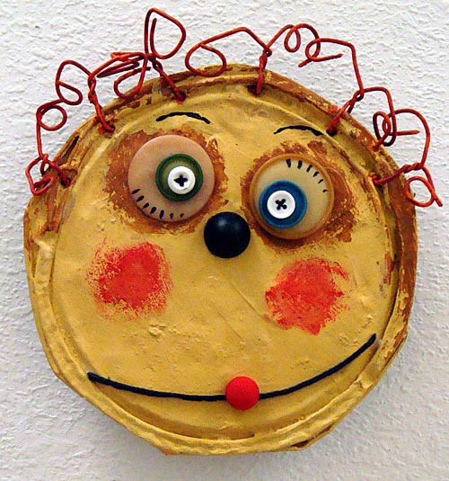 A painted face on an old tin can