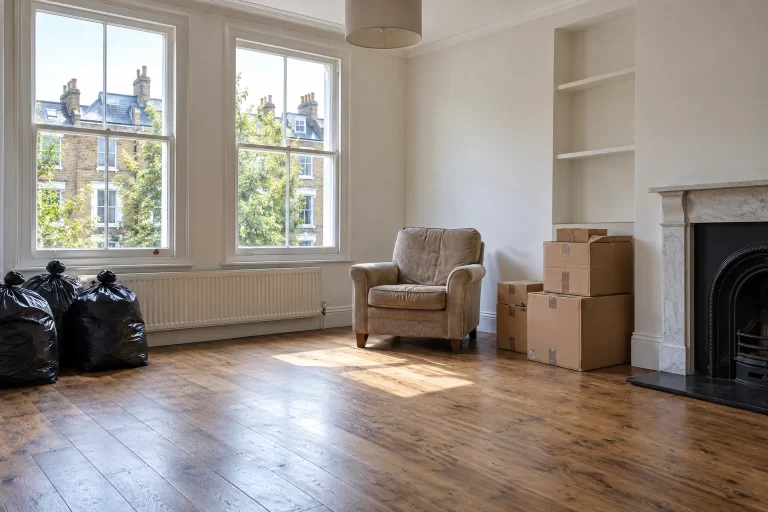 Rental flat after move-out with a few leftover bags and furniture awaiting an agreed clearance